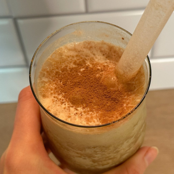 a glass filled with a protein shake