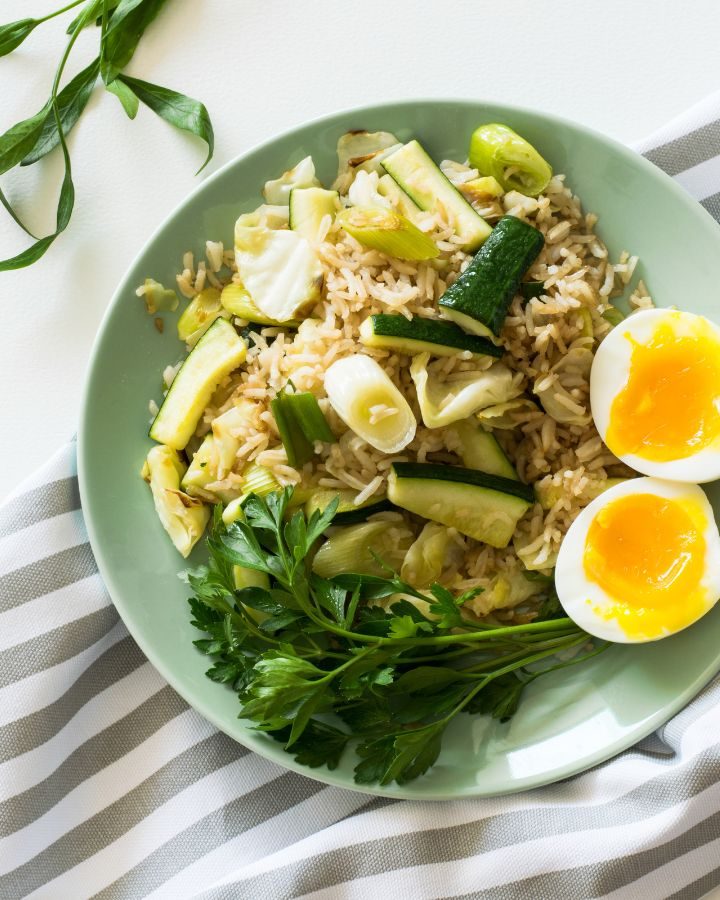 bowl of healthy food with rice, eggs, and vegetables