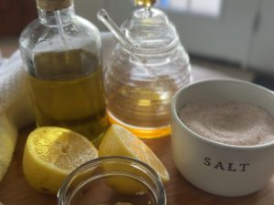 ingredients to make easy homemade salad dressing, including avocado oil, lemon, salt, and honey.