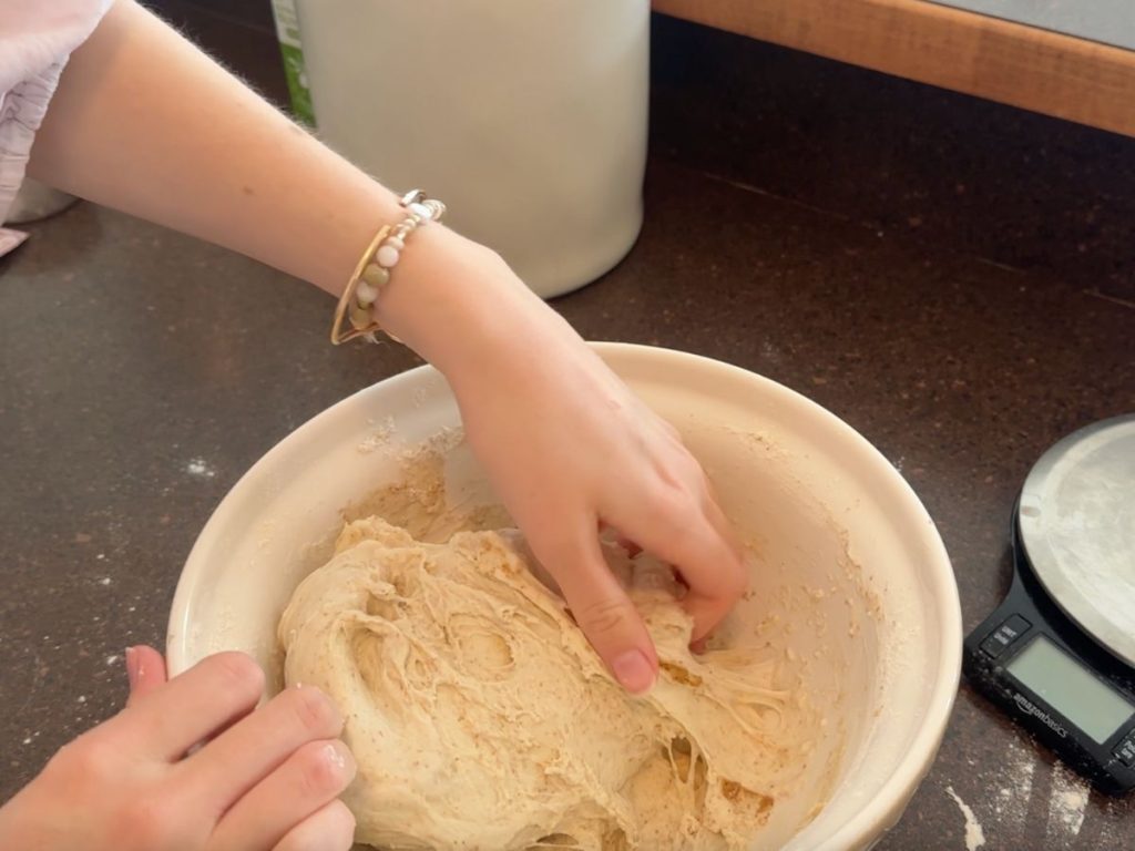 completing stretch and folds in sourdough pizza dough
