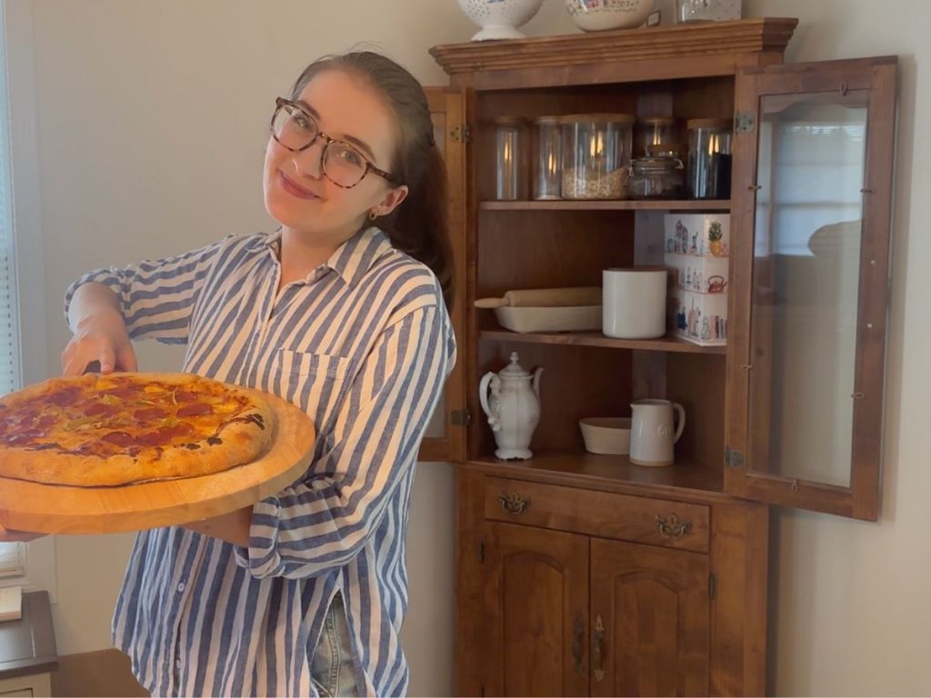 woman holding stuffed crust sourdough pizza
