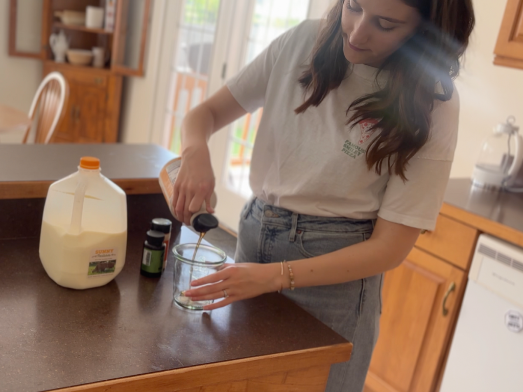 woman pouring maple syrup into glass